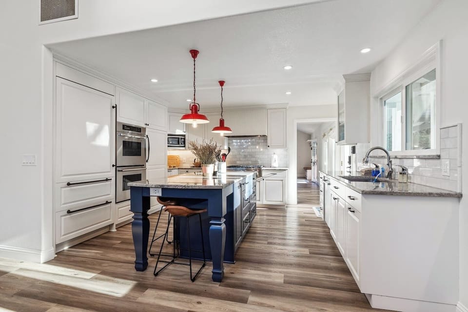 Remodeled kitchen with new appliances, double oven, 6 burner stove top, and large refrigerator.