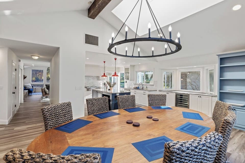 Large dining table that comfortably seats 12 adults.Next to the kitchen is a large countertop bar area with wine fridge.