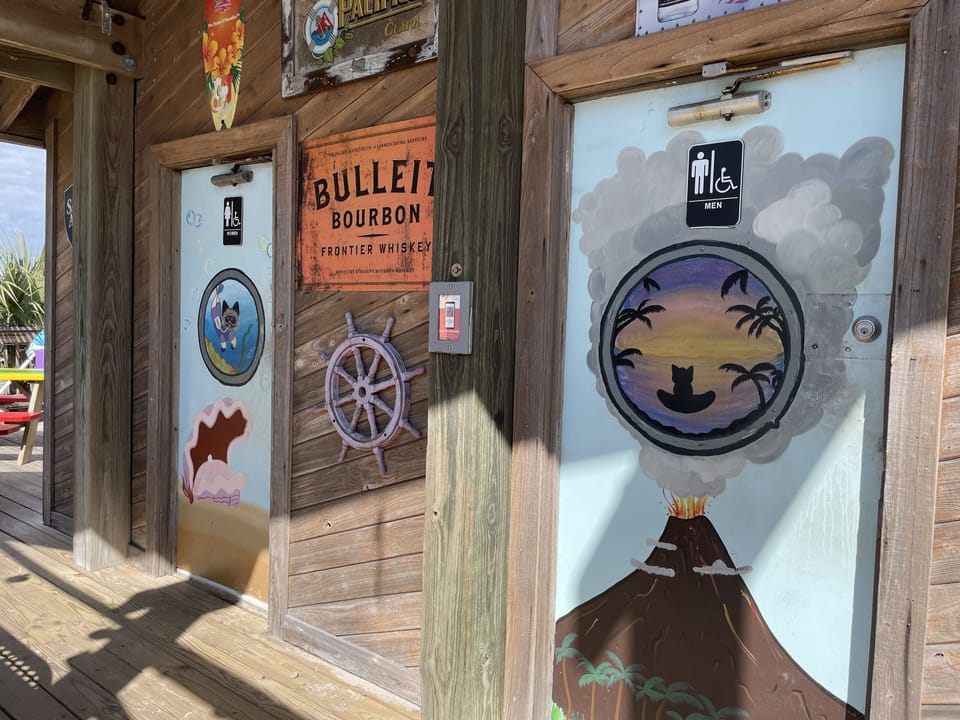 Coco's on the beach  - at the end of the boardwalk - bathrooms are always open.