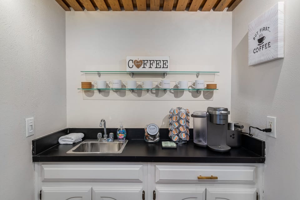 Coffee bar with espresso and coffee pods and sweetener packets. 