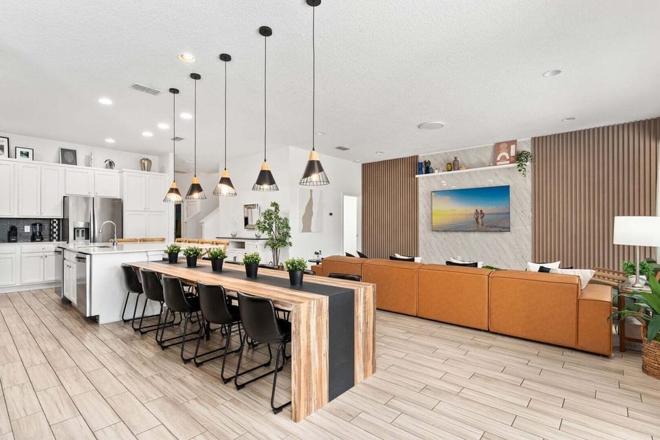 The living room, dining area, and kitchen seamlessly blend into one cohesive space.