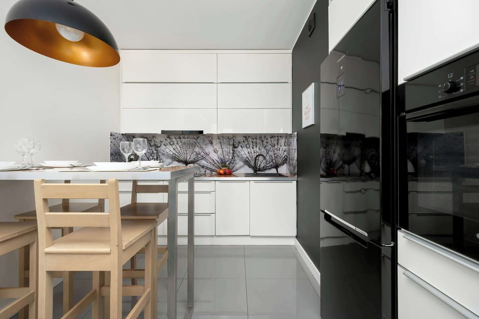 Functional kitchenette with white cabinets and quality appliances.