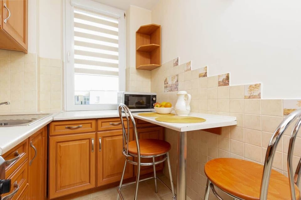 Kitchenette with plenty of kitchen utensils and dishes. 