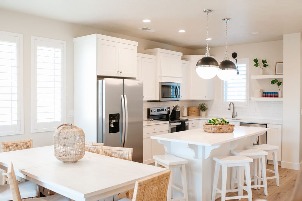 Fully equipped kitchen featuring island seating and stainless appliances.