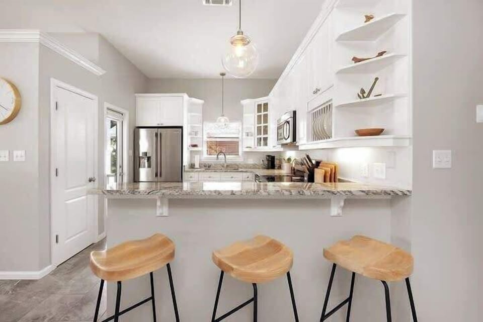 Our breakfast bar completes the kitchen space, with three stools to enjoy a light meal or an after the pool snack!