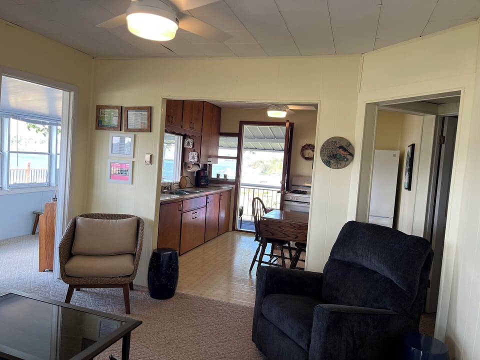 The living room is open to the kitchen and the closed-in porch.