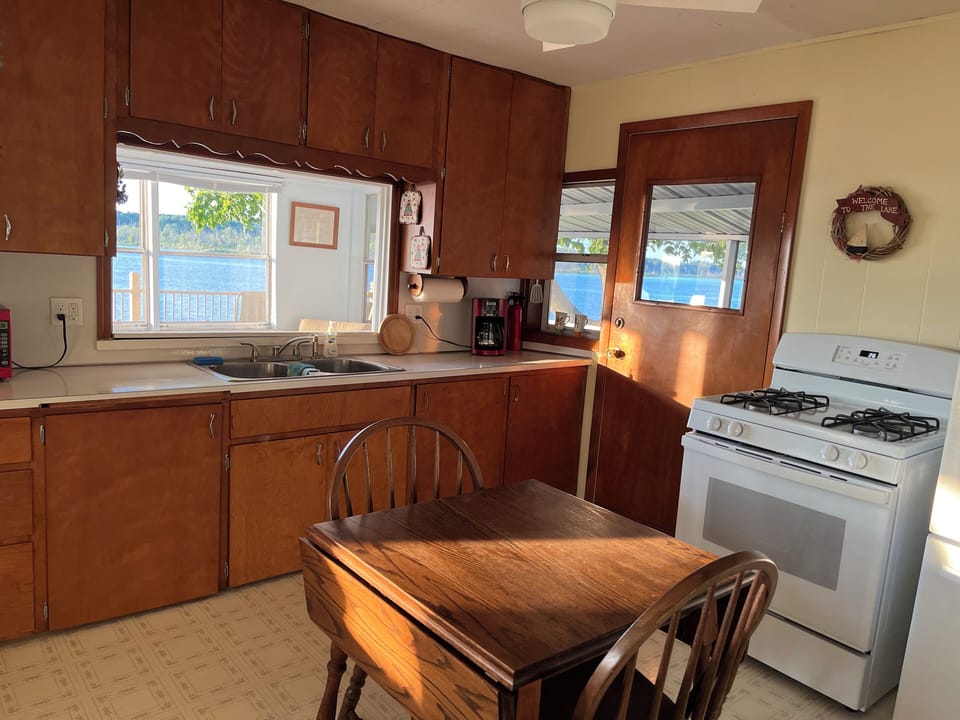 One can look out at the lake from the sink window.