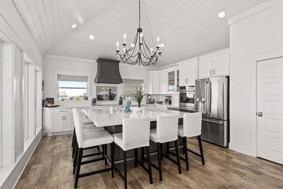 Fully stocked gourmet kitchen with stainless steel appliances and custom cabinetry.