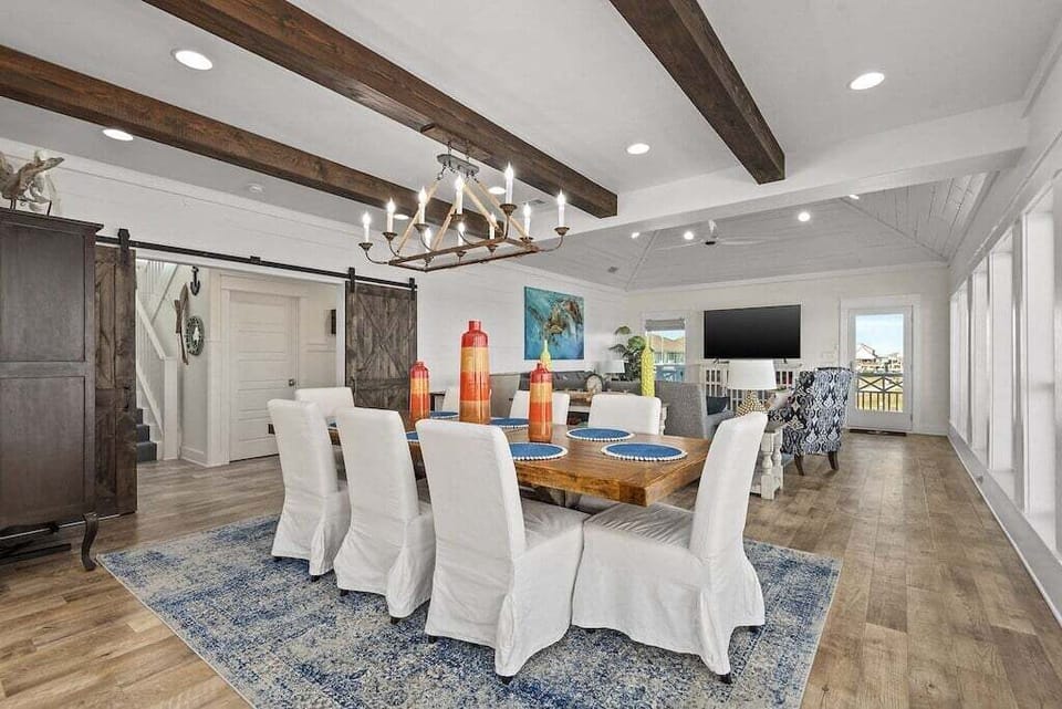 Spacious dining area with designer lighting and open flow to kitchen and living spaces.