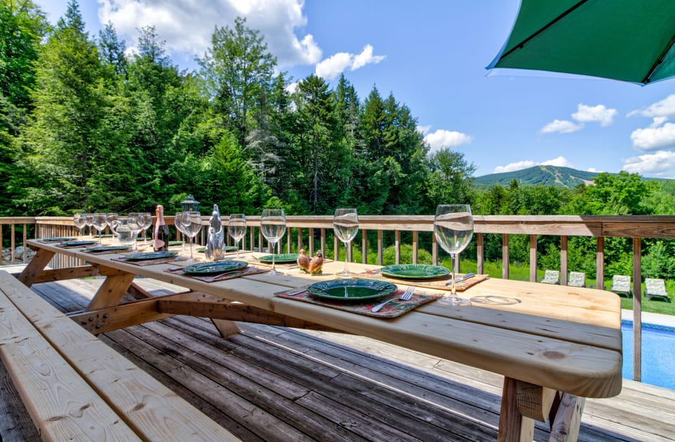 Huge outdoor picnic dining table seats lots of kids.