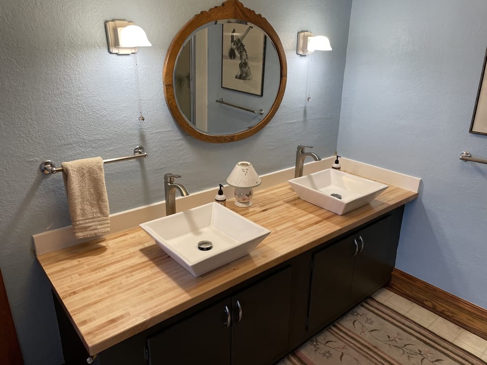 Upstairs 3/4 bathroom with 2 sinks , shower and a toilet.