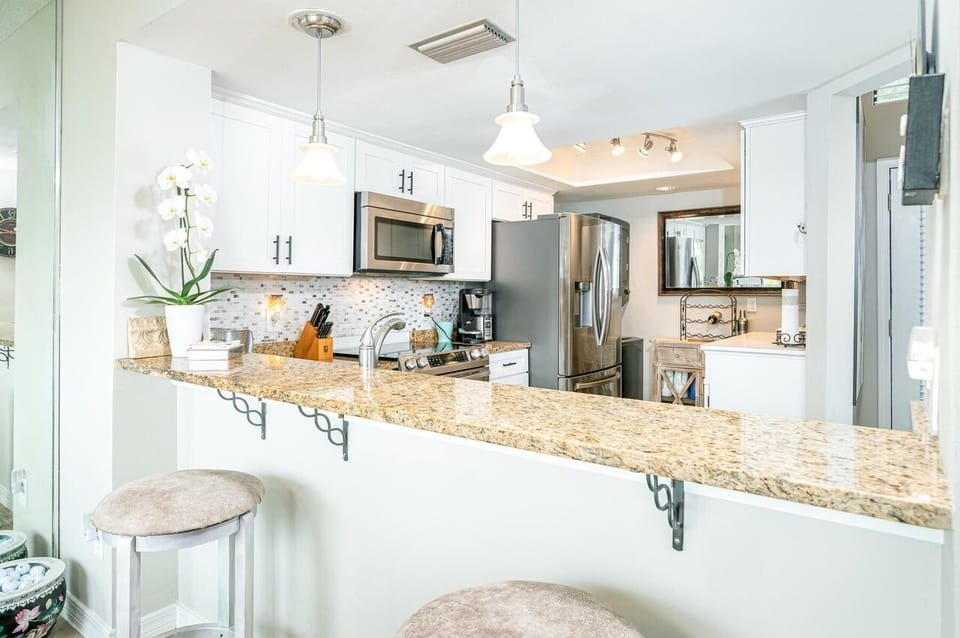 - Breakfast bar with granite counters and soft seating   - Bright kitchen space ready for quick snacks   - A welcoming spot to enjoy morning coffee together