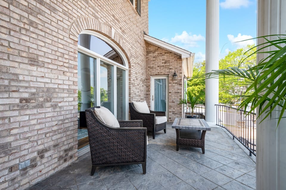 Large lake side porch with plenty of seating.
