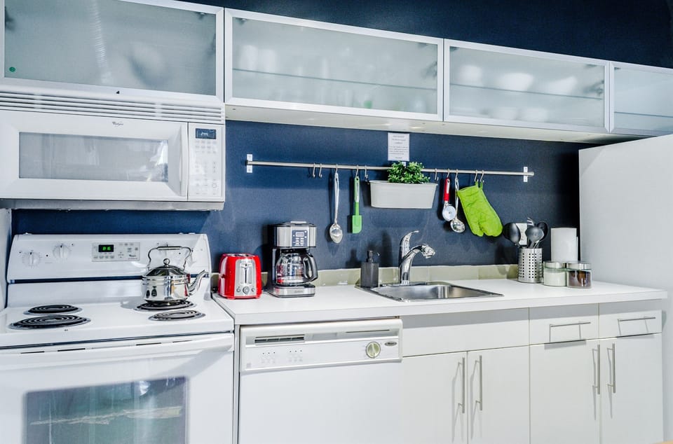 Kitchen: Equipped with clean appliances, this kitchen boasts lots of natural light and has everything you need for cooking and dining.