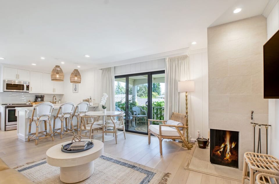 Enjoy the cozy ambience of the fireplace and easy access to the balcony in the condo’s adorable living room
