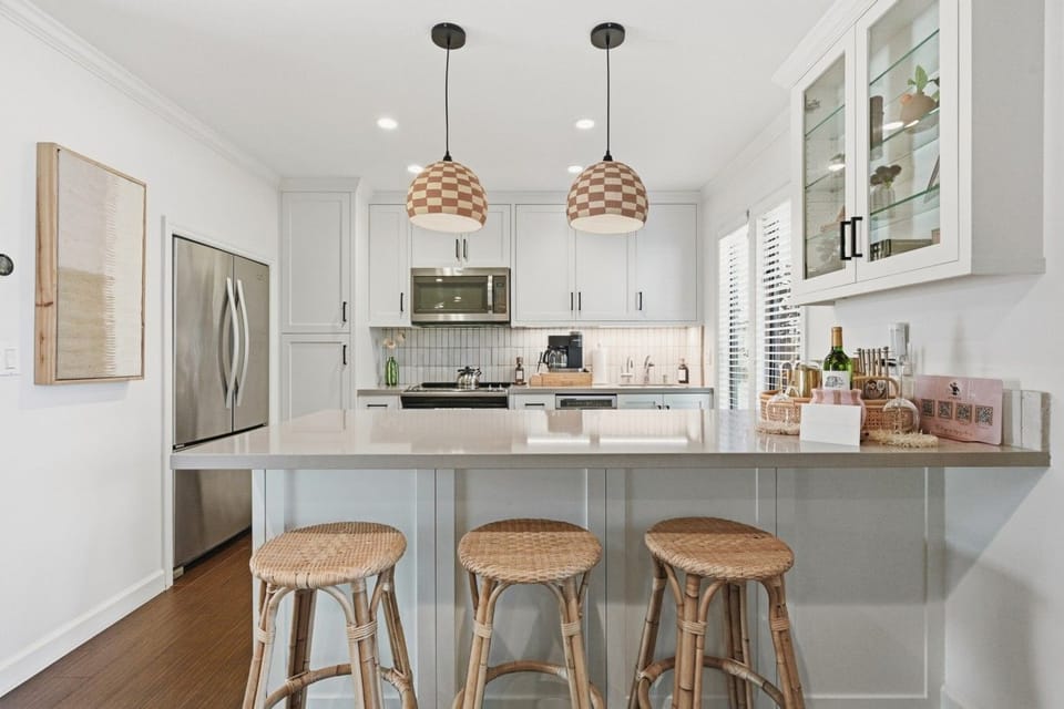 Bright, updated full kitchen with stainless steel appliances, generous counter space and seating for three at the breakfast bar.