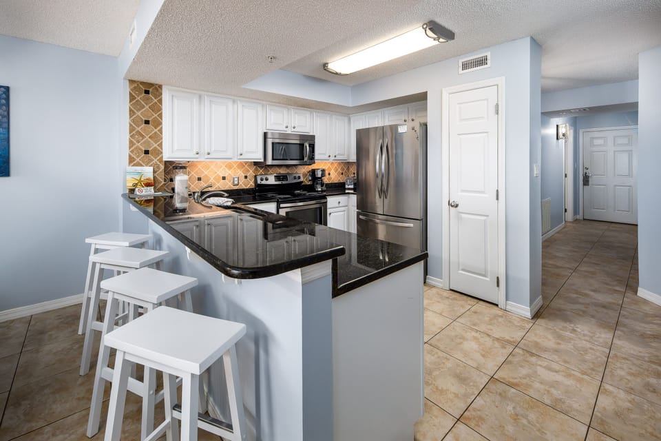 Kitchen - A nice big kitchen with granite counter tops in this unit.  There is 4 additional seats at the breakfast bar.