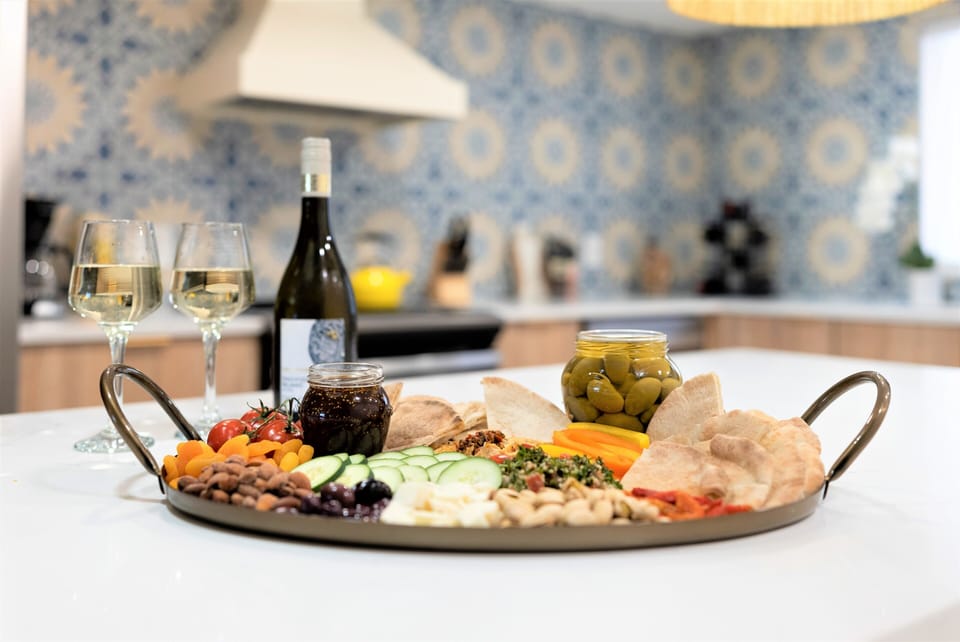 Unwind after a day at the beach with a glass of wine and a charcuterie board