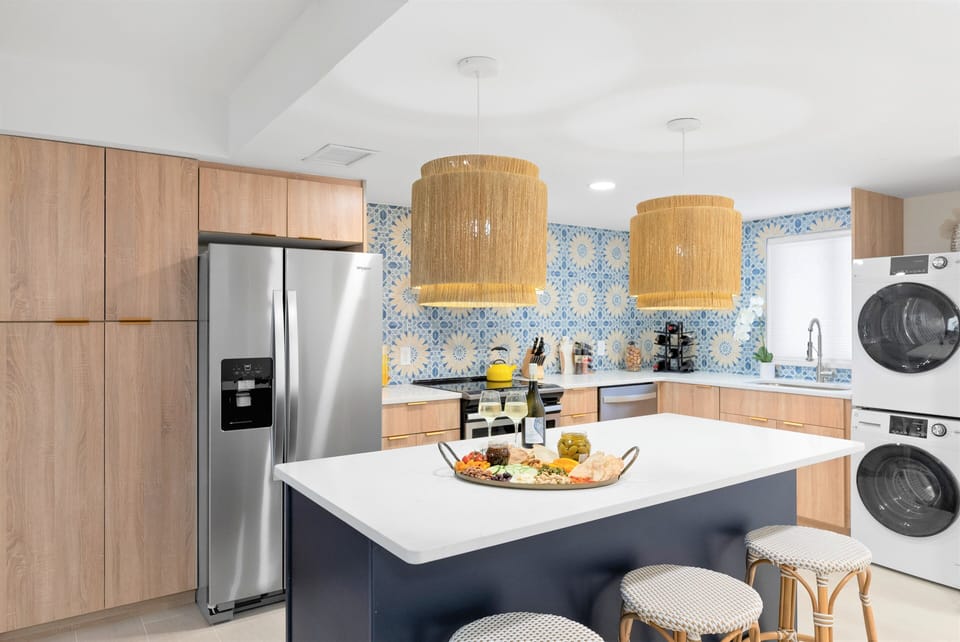 Gourmet kitchen with custom tile backsplash and high-end finishes - lots of storage & laundry!