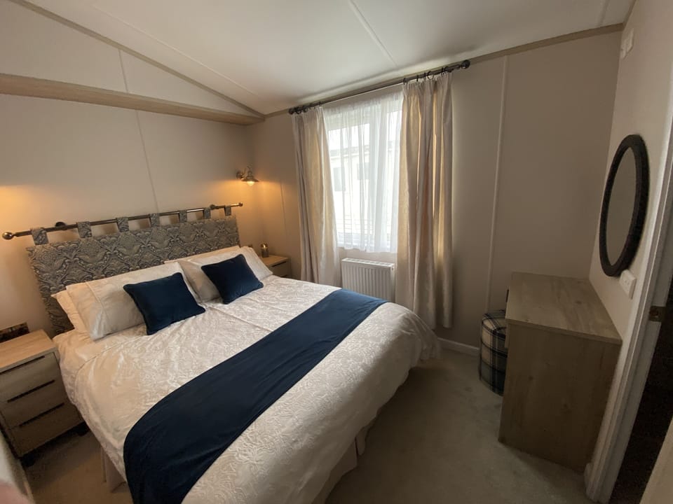 Master bedroom with king size bed and ensuite bathroom.