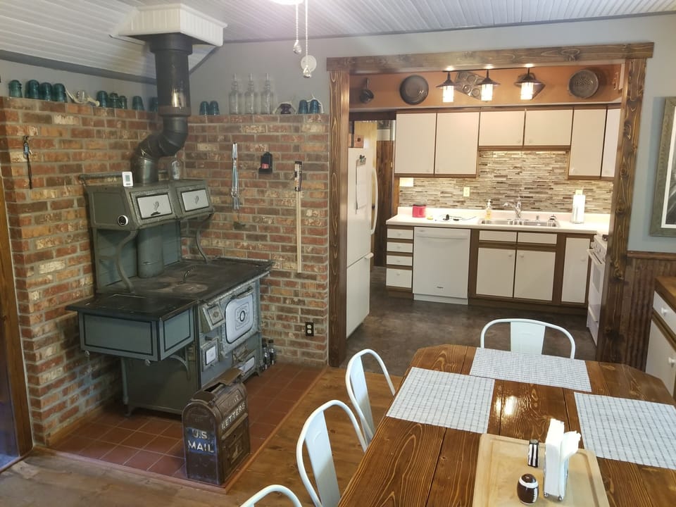 Dining room area with antique stove.