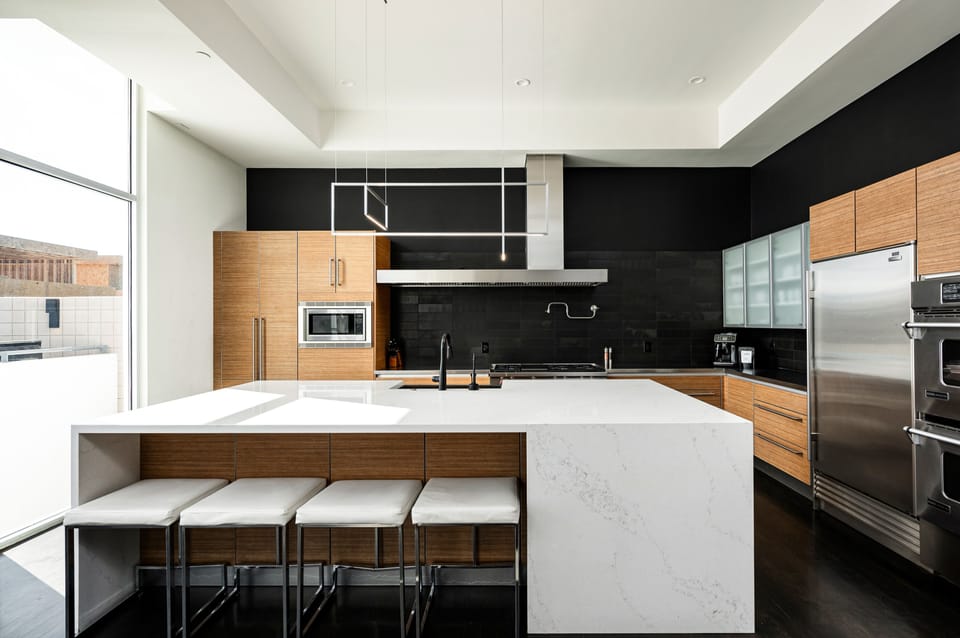 Indulge in culinary luxury at The George. This modern kitchen features sleek finishes, top-tier appliances, and a spacious design, perfect for creating memorable dining experiences in Arizona's premier short-term rental.