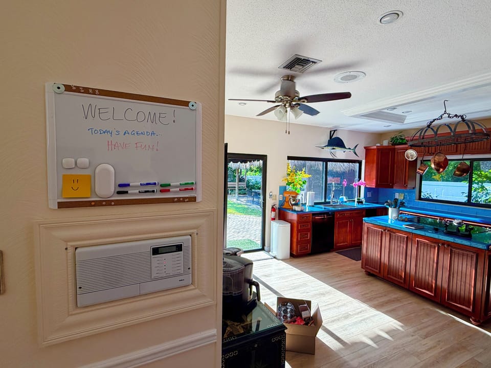 Large kitchen includes message whiteboard.