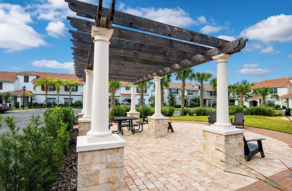 Outdoor Pergola with Picnic Seating on Paved Patio