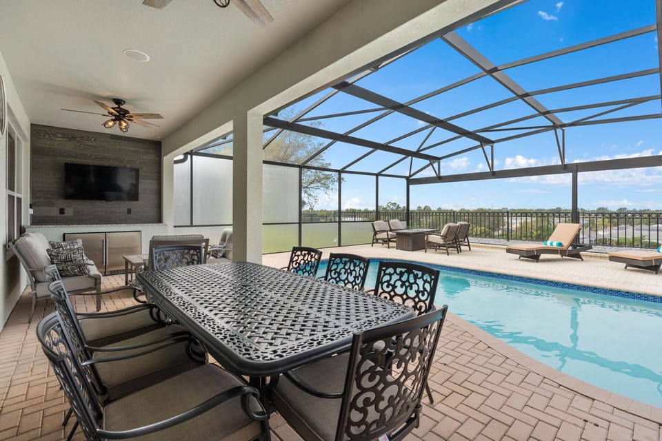 8 Person dining set, outdoor tv, extra seating and 2 outdoor fridges.