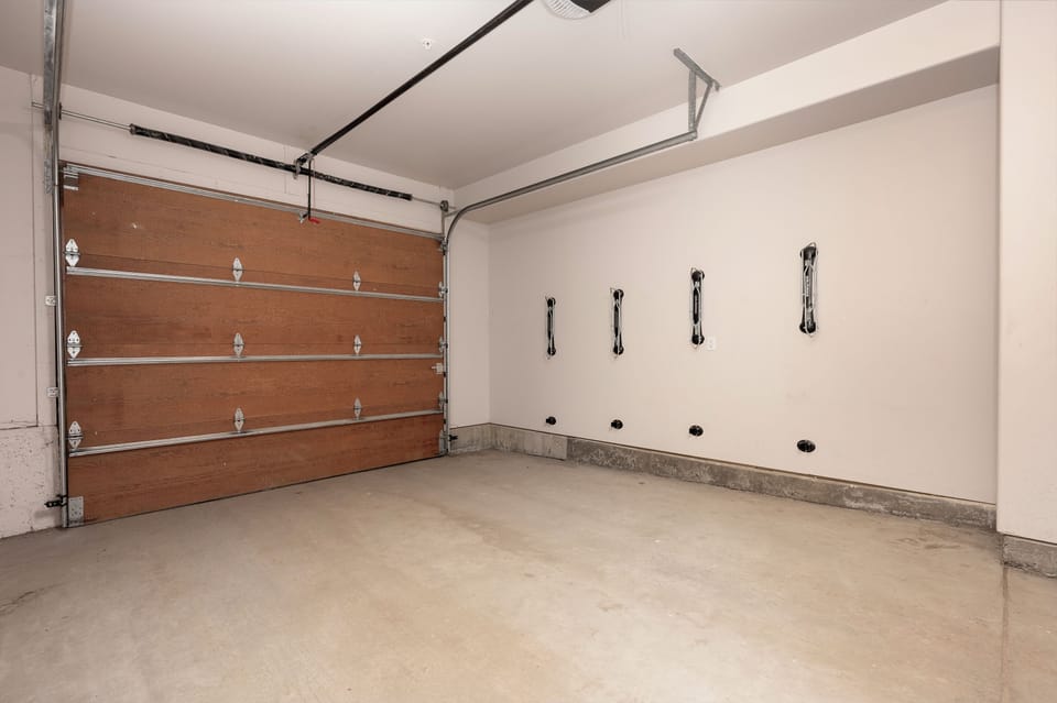 A heated garage with space for two compact vehicles.