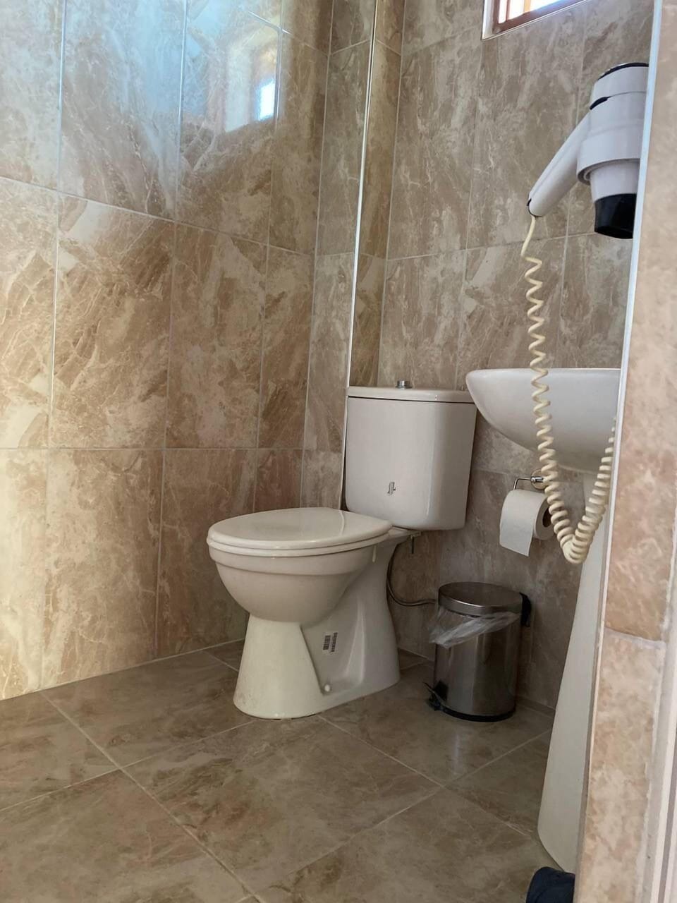Shower, hair dryer, towels, toilet paper