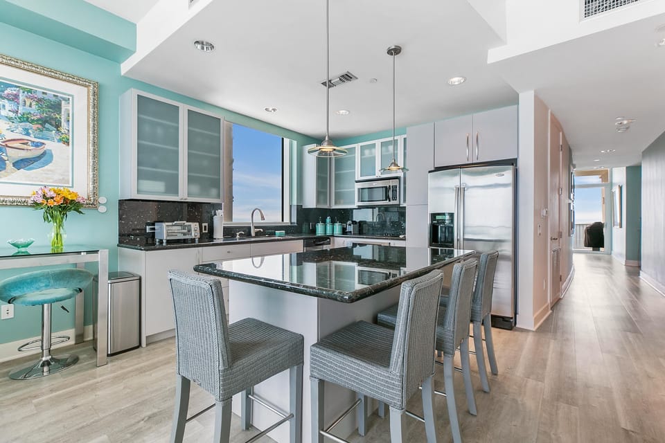 Fully equipped kitchen with a large window overlooking the bay