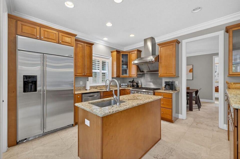 Fully stocked chef’s kitchen with modern design and ample space