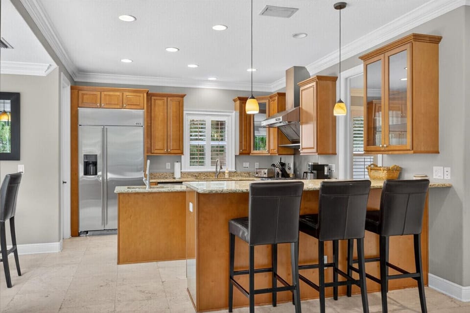 Open kitchen with bar seating and premium finishes