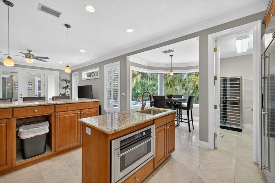 Elegant kitchen with breakfast nook overlooking the pool
