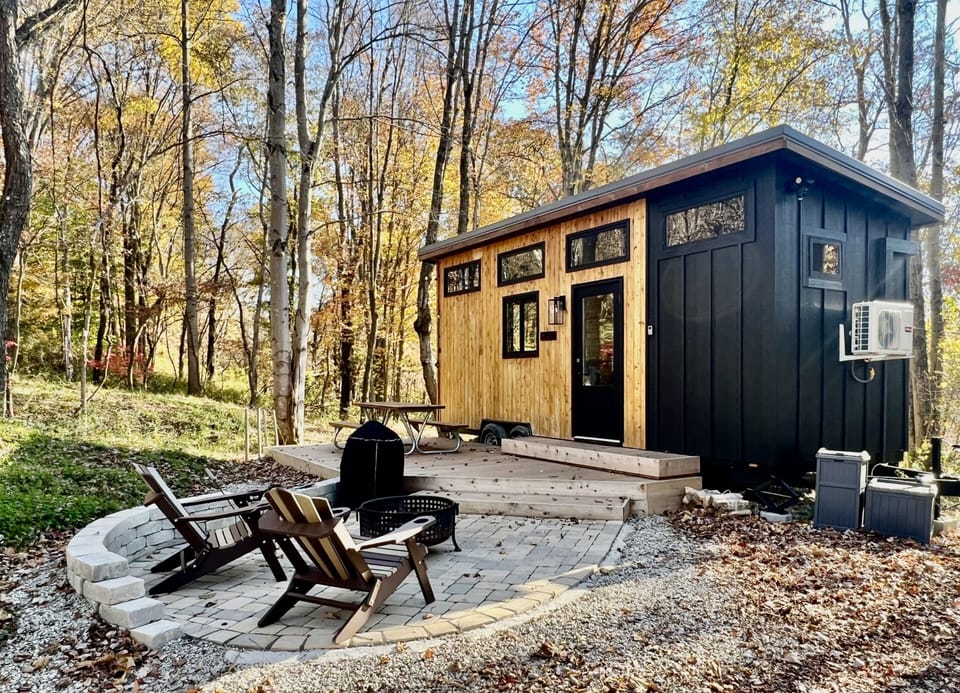 Outside, there's a nice deck with picnic table and paver patio with fire pit and Adirondack chairs.