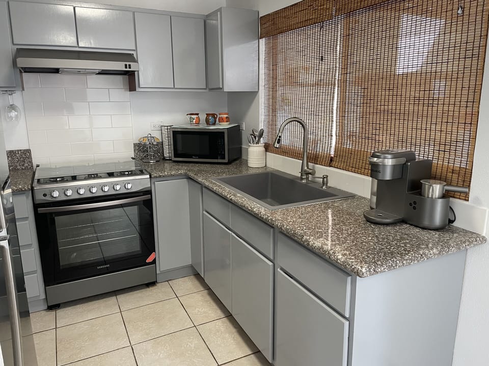 Kitchen with gas stove and full size fridge 