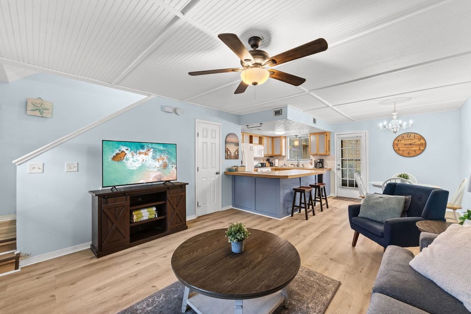 Coastal living room with smart TV and new luxury vinyl floors.
