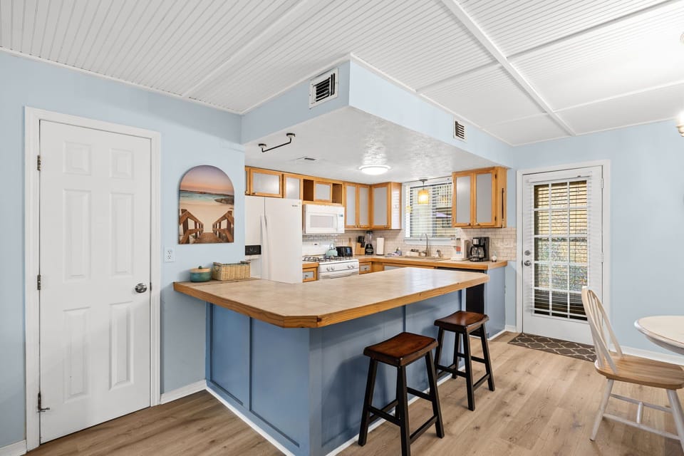 Blue breakfast bar, gas range, full appliances, bar seating for two. 