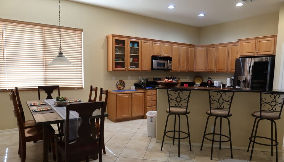 View of the kitchen with a kitchen table and island for eating. Granite counters