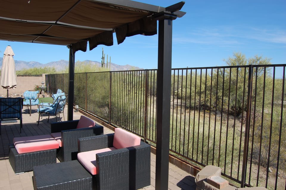 View of patio with covered seating area and comfy furniture