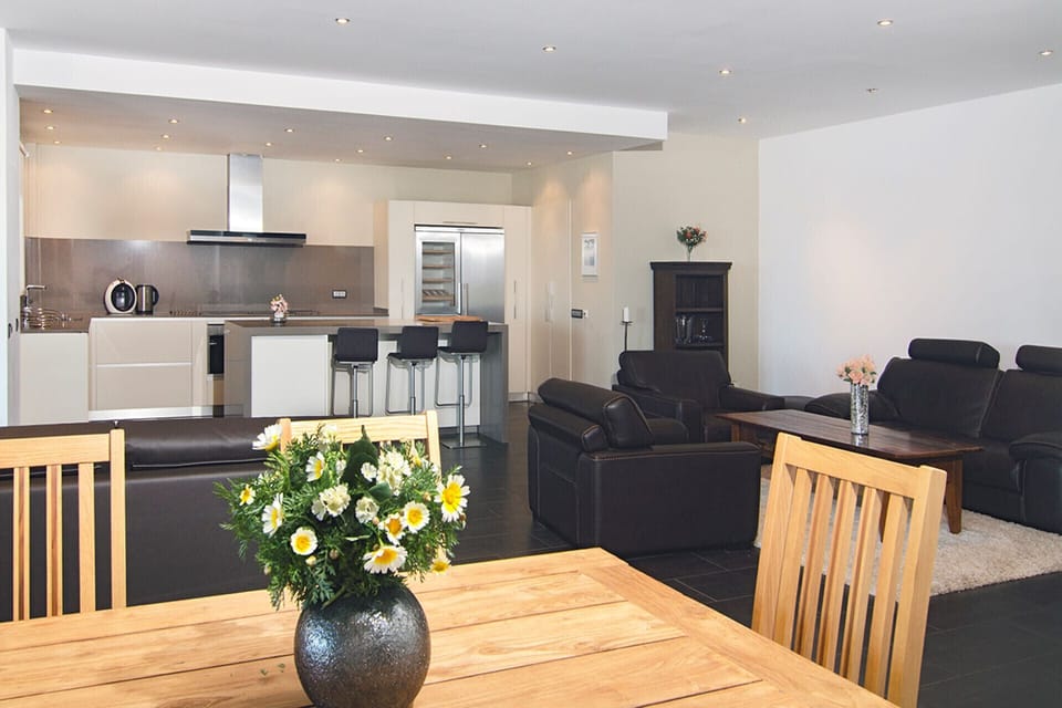 Opposite the large dining table in the living room is Casa Aurora's open-plan, modern kitchen.