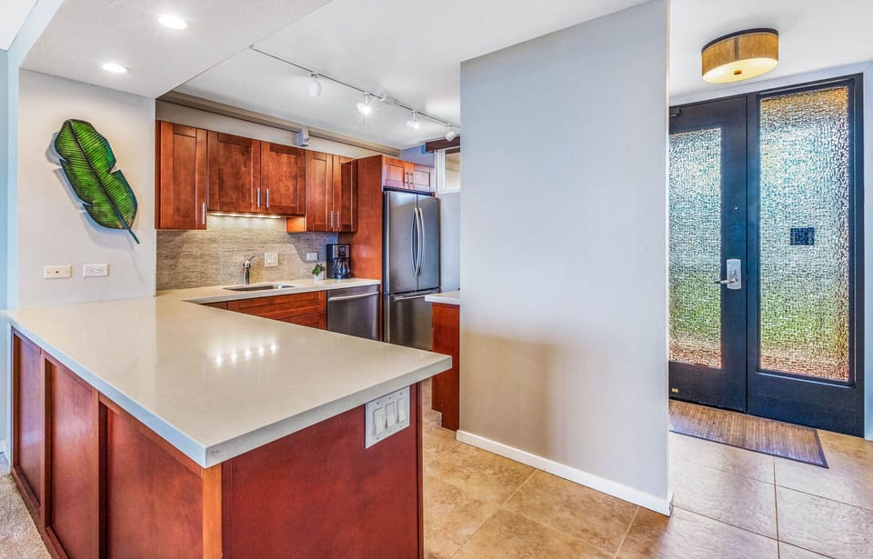 Gourmet kitchen with quartz counter tops and stainless steel appliances.
