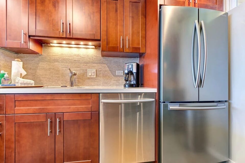 Kitchen is complete with dishwasher, fridge, microwave, coffeemaker & blender