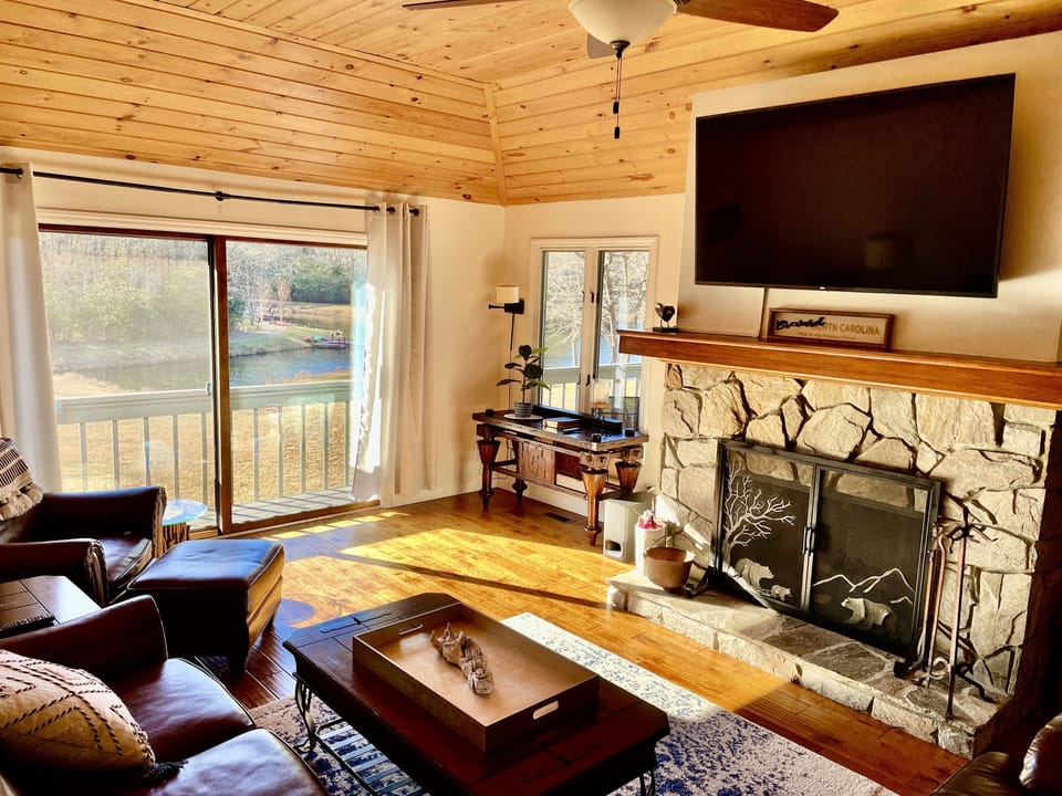Family room ,lake views,  fireplace, reclining love seat, couch and comfy chair 