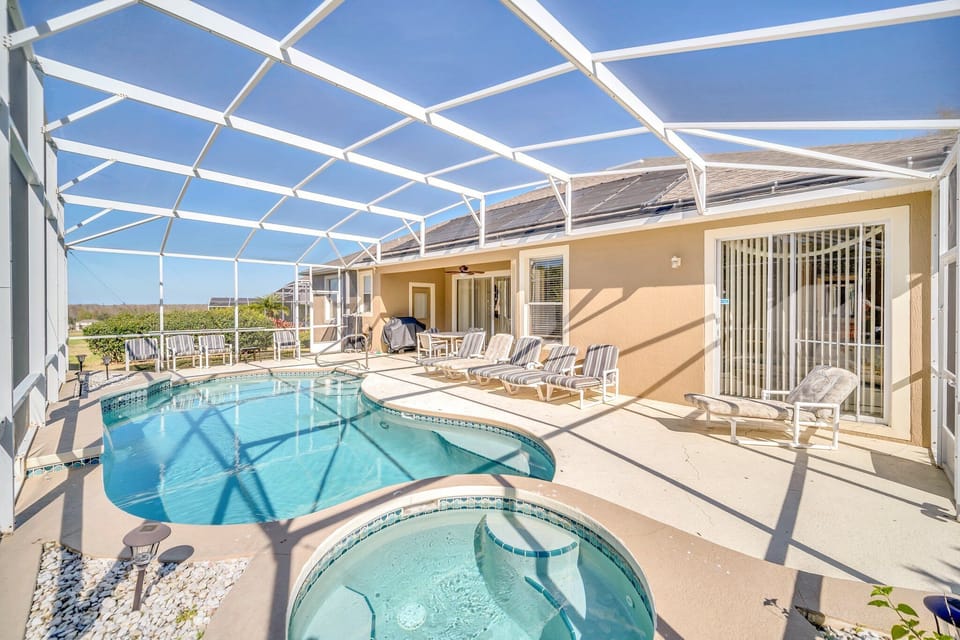 Step into pure relaxation with this sparkling private screened-in pool and spa, perfect for cooling off.
