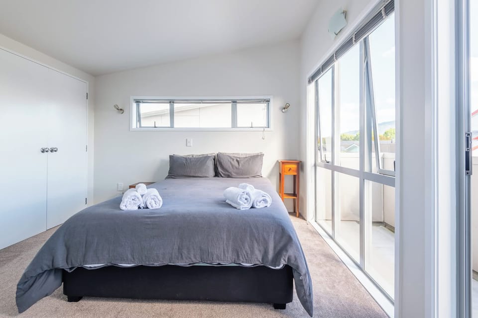 The upstairs queen room catches the afternoon sun and opens to the balcony.