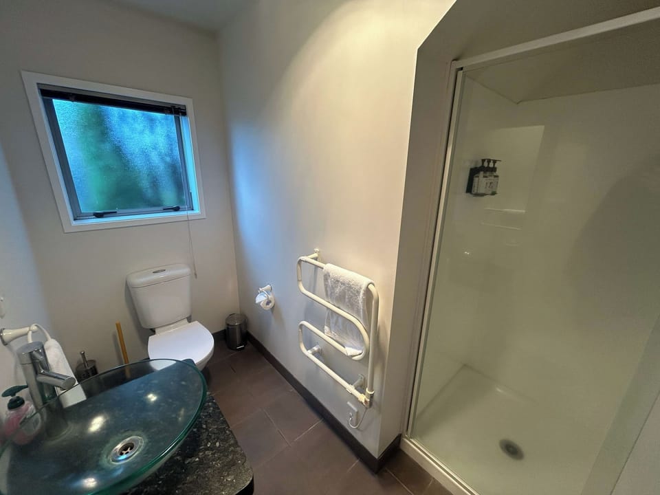 The second bathroom has a shower, toilet and a heated towel rail.