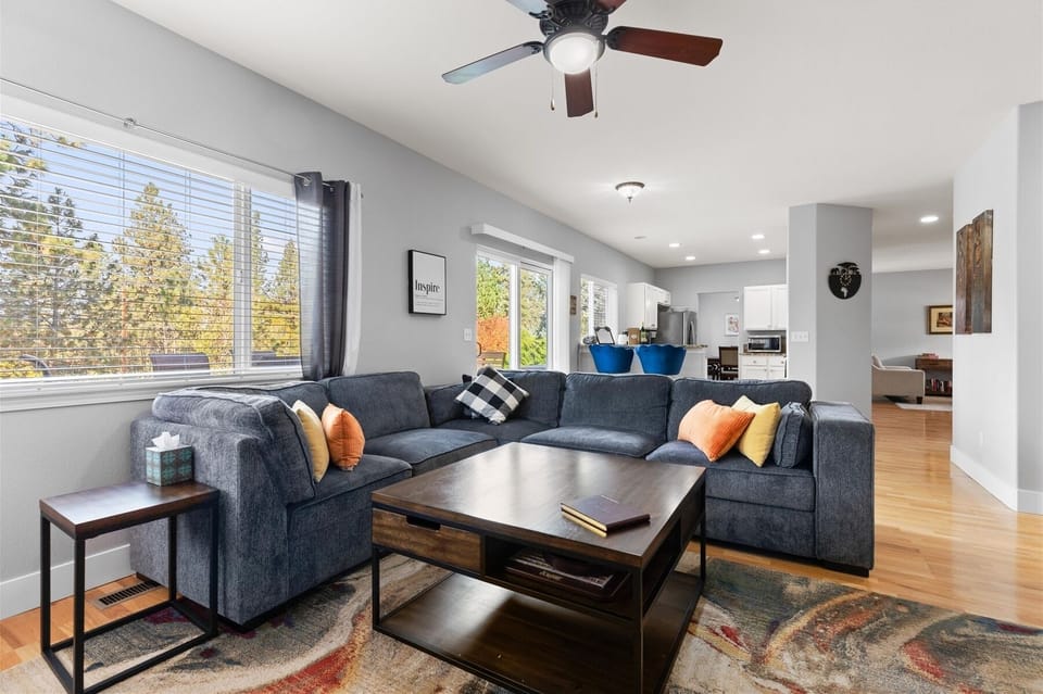 Living room overlooks fenced backyard