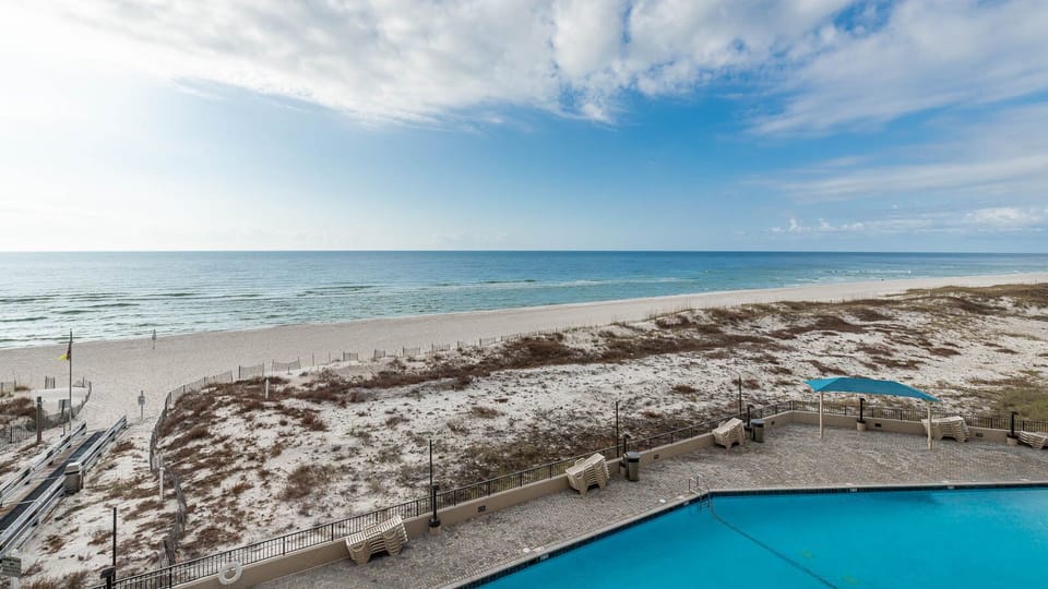 Take in the serene views of the water while relaxing by the inviting pool area, perfect for sunbathing and unwinding